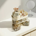 Makeup organizer with brushes, bottles, and drawers on a vanity next to a round mirror