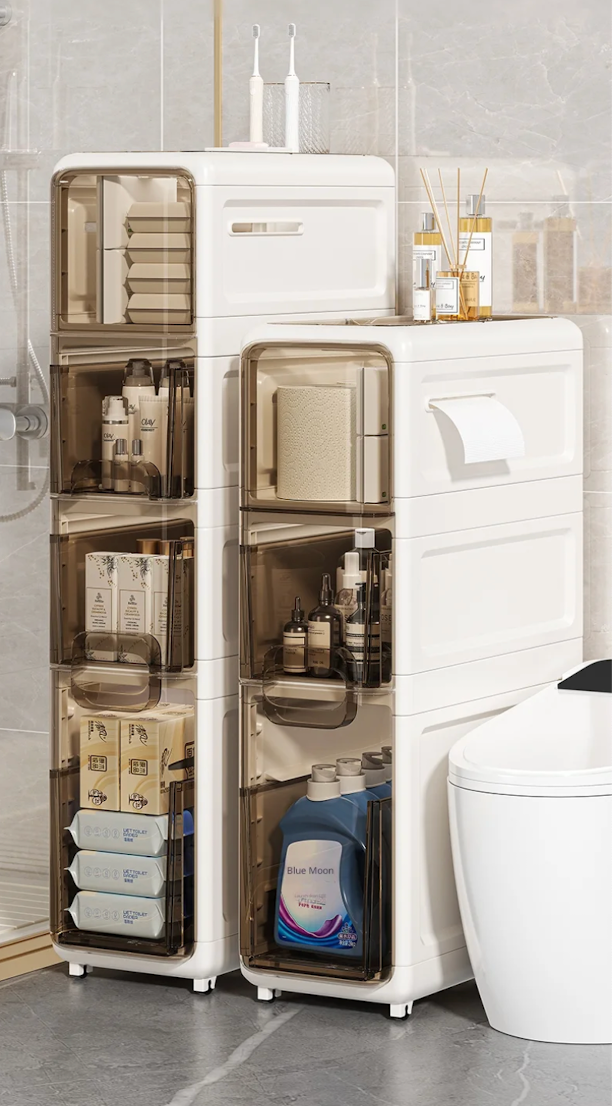 White storage cabinet with transparent doors in a bathroom setting.